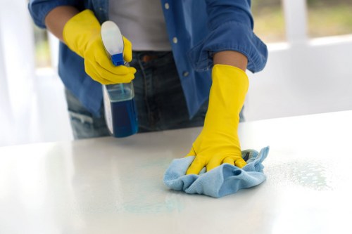 Team member applying cleaning controls in a workplace